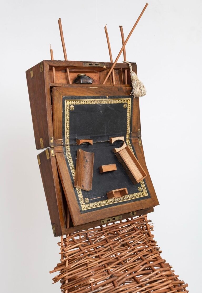 Antique Writing Desks Converge with African Masks in Sonia E. Barrett’s Sculptures