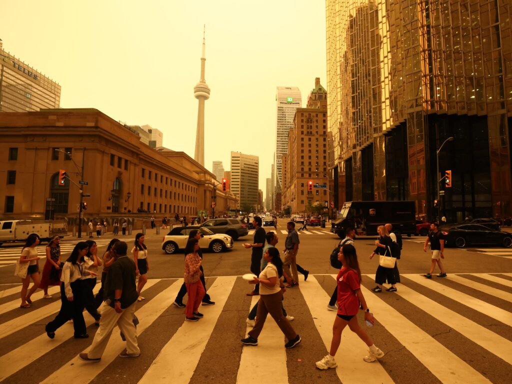 Canadian wildfires are shrouding US cities in smoke and yellow haze. See the eerie photos.